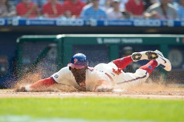 Didi Gregorius of the Philadelphia Phillies slides home safely in the bottom of the first inning against the Miami Marlins during Game One of the...