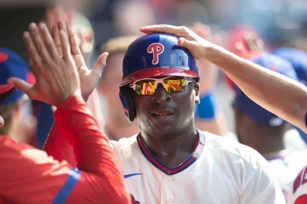 Didi Gregorius of the Philadelphia Phillies high fives his teammates after scoring a run against the Miami Marlins during Game One of the...