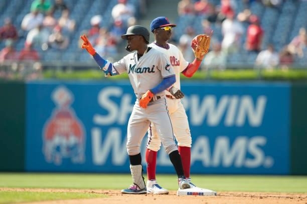 Jazz Chisholm Jr. #2 of the Miami Marlins reacts in front of Didi Gregorius of the Philadelphia Phillies during Game One of the doubleheader at...