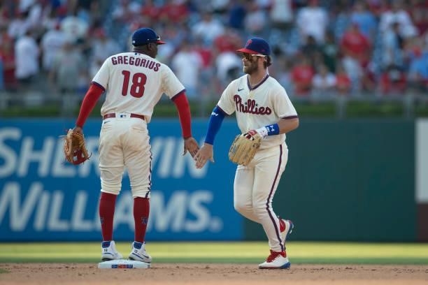 Didi Gregorius and Bryce Harper of the Philadelphia Phillies celebrate their win against the Miami Marlins during Game One of the doubleheader at...