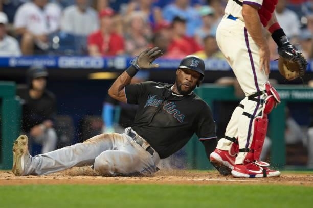 Starling Marte of the Miami Marlins slides home safely to score a run in the top of the third inning against the Philadelphia Phillies during Game...