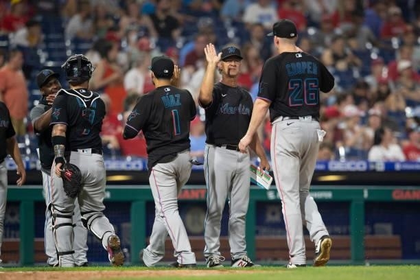 Manager Don Mattingly of the Miami Marlins high fives Garrett Cooper after the game Philadelphia Phillies during Game Two of the doubleheader at...