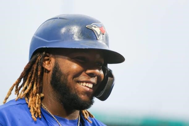 Vladimir Guerrero Jr. #27 of the Toronto Blue Jays smiles while on deck during the third inning against the Texas Rangers at Sahlen Field on July 16,...