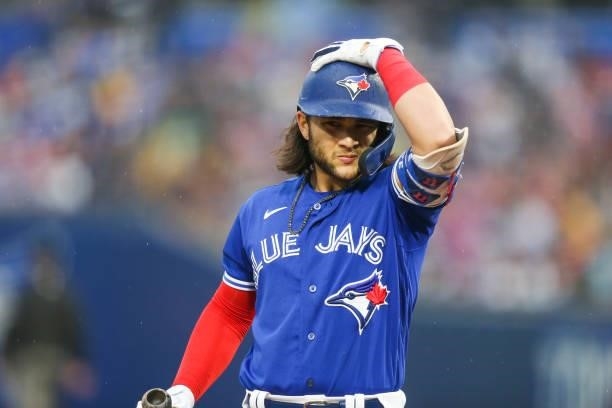 Bo Bichette of the Toronto Blue Jays adjusts his helmet while at bat during the third inning against the Texas Rangers at Sahlen Field on July 16,...
