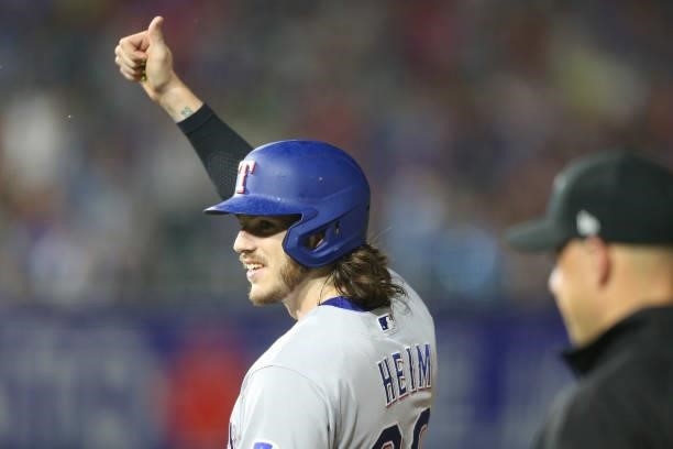 Jonah Heim of the Texas Rangers gives a thumbs-up at the fans after hitting a single during the seventh inning against the Toronto Blue Jays at...