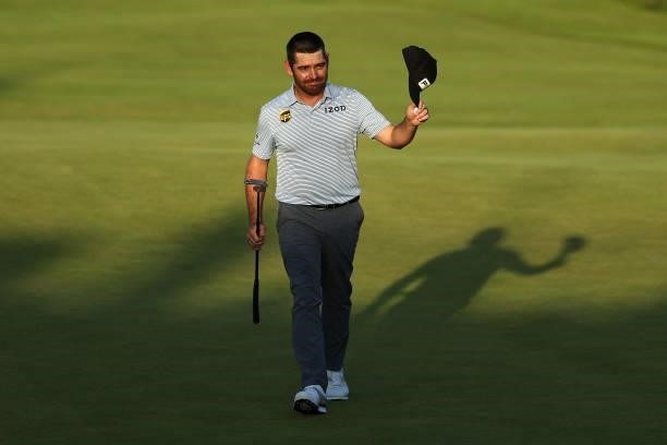 Louis Oosthuizen of South Africa acknowledges the crowd after finishing his round on the 18th green during Day Three of The 149th Open at Royal St...