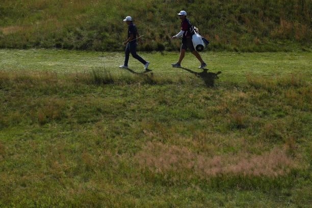 Collin Morikawa of United States and caddie walk during Day Three of The 149th Open at Royal St George’s Golf Club on July 17, 2021 in Sandwich,...