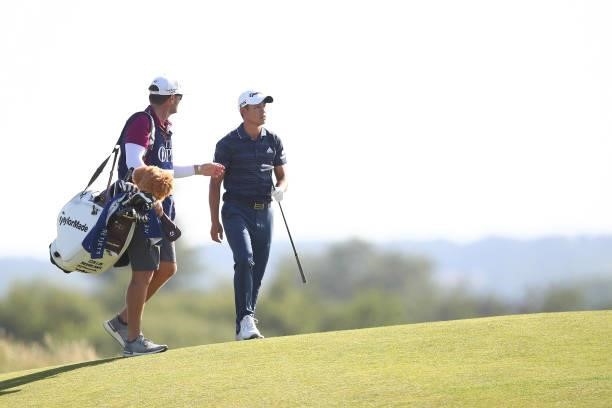 Collin Morikawa of the United States talks with caddie Jonathan Jakovac on the seventh hole during Day Three of The 149th Open at Royal St George’s...