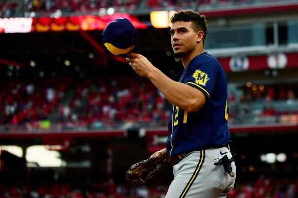 Willy Adames of the Milwaukee Brewers puts on his hat during a game between the Milwaukee Brewers and Cincinnati Reds at Great American Ball Park on...