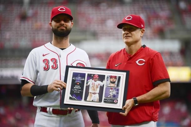 Jesse Winker of the Cincinnati Reds is honored with a plaque for his All-Star game appearance prior to their game against the Milwaukee Brewers at...