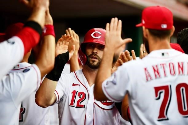 Tyler Naquin of the Cincinnati Reds celebrates in the dugout during a game between the Milwaukee Brewers and Cincinnati Reds at Great American Ball...