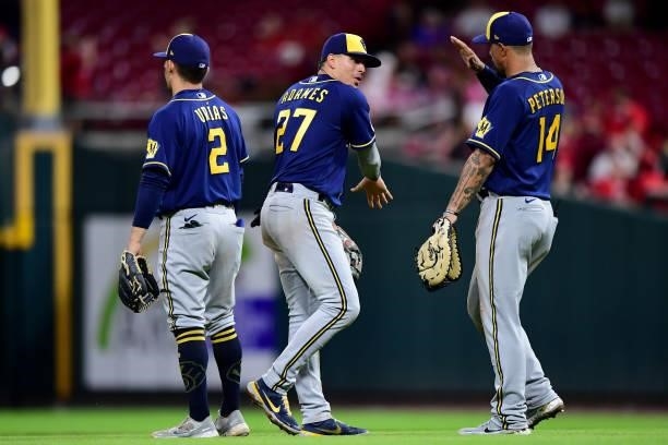 Luis Urias, Willy Adames and Jace Peterson of the Milwaukee Brewers celebrate their win during a game between the Milwaukee Brewers and Cincinnati...