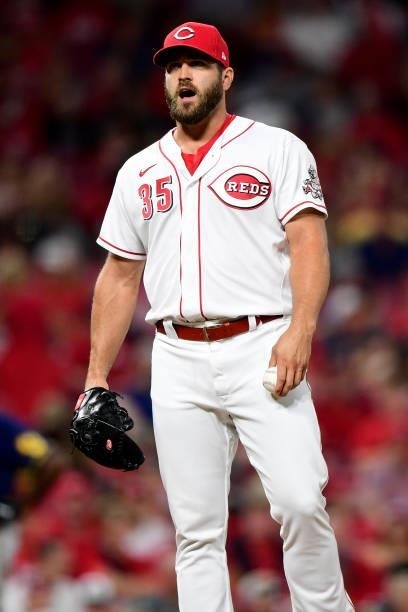Josh Osich of the Cincinnati Reds reacts during a game between the Milwaukee Brewers and Cincinnati Reds at Great American Ball Park on July 16, 2021...