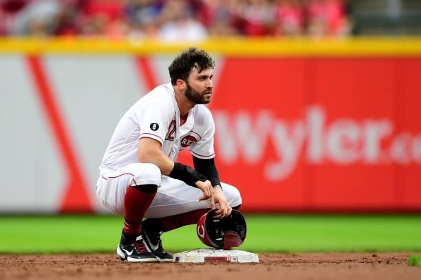 Tyler Naquin of the Cincinnati Reds kneels at second base during a game between the Milwaukee Brewers and Cincinnati Reds at Great American Ball Park...