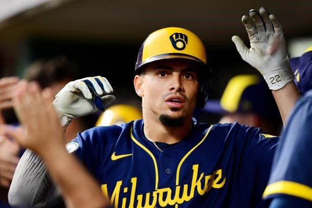 Willy Adames of the Milwaukee Brewers celebrates in the dugout during a game between the Milwaukee Brewers and Cincinnati Reds at Great American Ball...