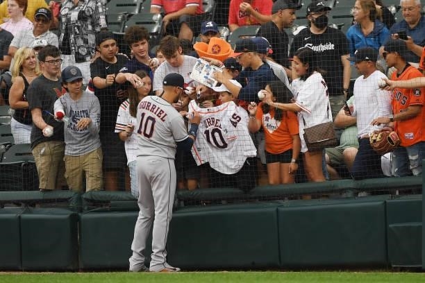 Yuli Gurriel of the Houston Astros signs autographs before the game between the Houston Astros and the Chicago White Sox at Guaranteed Rate Field on...
