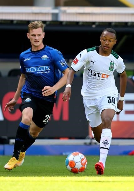 Jannis Heuer of Paderborn challenges Yvandro Borges Sanches of Moenchengladbach runs with the ball during the pre-season match between SC Paderborn...