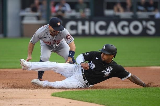 Jose Altuve of the Houston Astros tags out Leury Garcia of the Chicago White Sox in the second inning at Guaranteed Rate Field on July 17, 2021 in...