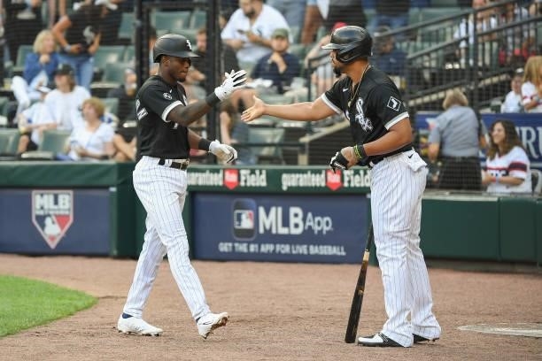 Tim Anderson of the Chicago White Sox celebrates with Jose Abreu after Anderson's home run in the third inning against the Houston Astros at...