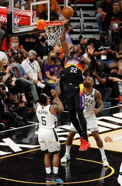 Deandre Ayton of the Phoenix Suns goes up for a shot against Jeff Teague and P.J. Tucker of the Milwaukee Bucks during the first half in Game Five of...