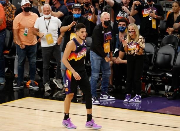 Devin Booker of the Phoenix Suns celebrates a basket against the Milwaukee Bucks during the first half in Game Five of the NBA Finals at Footprint...