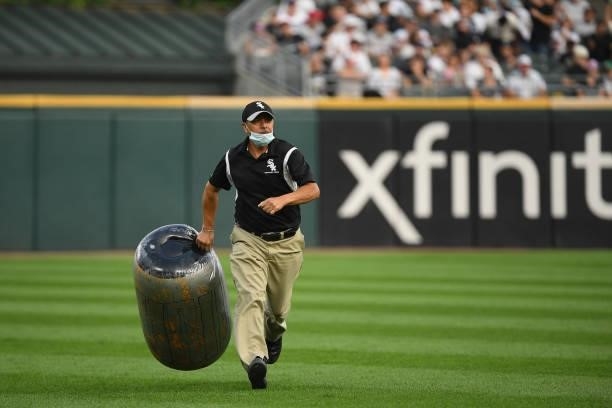 Member of Chicago White Sox grounds crew retrieves an item from the outfield during the fourth inning of the game between the Houston Astros and the...