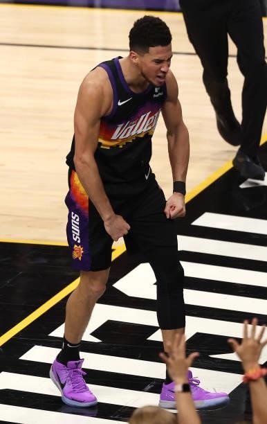 Devin Booker of the Phoenix Suns celebrates a dunk against the Milwaukee Bucks during the first half in Game Five of the NBA Finals at Footprint...