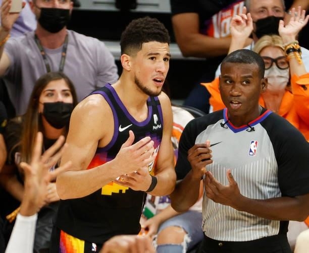 Devin Booker of the Phoenix Suns argues with referee James Williams during the first half in Game Five of the NBA Finals against the Milwaukee Bucks...
