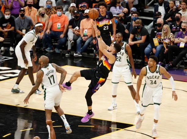 Devin Booker of the Phoenix Suns shoots against the Milwaukee Bucks during the first half in Game Five of the NBA Finals at Footprint Center on July...