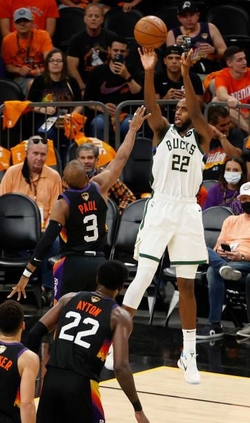 Khris Middleton of the Milwaukee Bucks shoots against Chris Paul of the Phoenix Suns during the second half in Game Five of the NBA Finals at...