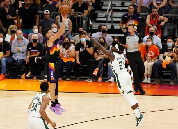 Devin Booker of the Phoenix Suns shoots against Jrue Holiday of the Milwaukee Bucks during the second half in Game Five of the NBA Finals at...