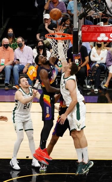 Deandre Ayton of the Phoenix Suns goes up for a shot against Brook Lopez of the Milwaukee Bucks during the second half in Game Five of the NBA Finals...