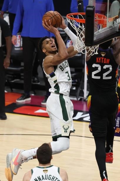 Giannis Antetokounmpo of the Milwaukee Bucks goes up for a shot against Deandre Ayton of the Phoenix Suns during the second half in Game Five of the...