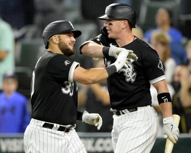Jake Burger celebrates with Zack Collins of the Chicago White Sox after hitting his first Major League home run in the seventh inning against Austin...