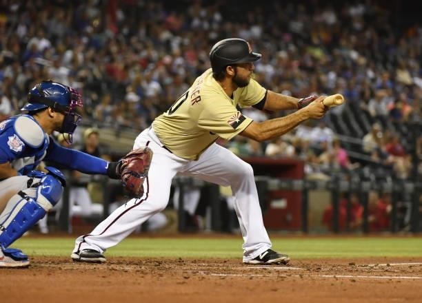 Madison Bumgarner of the Arizona Diamondbacks gets ready to attempt a bunt against the Chicago Cubs at Chase Field on July 16, 2021 in Phoenix,...