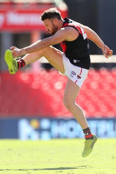 Cale Hooker of Essendon kicks the ball during the round 18 AFL match between North Melbourne Kangaroos and Essendon Bombers at Metricon Stadium on...