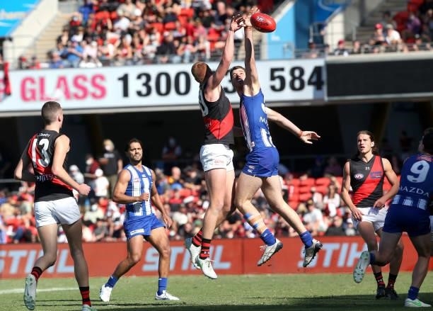 Peter Wright of the Bombers and Tristan Xerri of the Kangaroos compete during the round 18 AFL match between North Melbourne Kangaroos and Essendon...