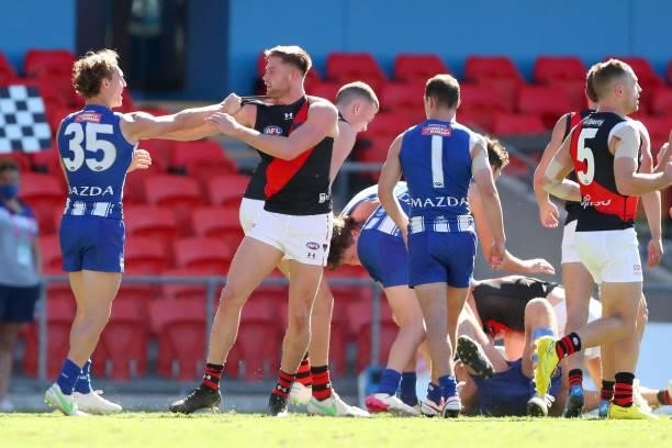 Jayden Laverde of Essendon and Charlie Lazzaro of North Melbourne scuffle during the round 18 AFL match between North Melbourne Kangaroos and...