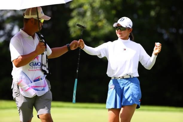 Yuri Yoshida of Japan fist bumps with her caddie after the birdie on the 3rd green during third round of the GMO Internet Ladies Samantha Thavasa...