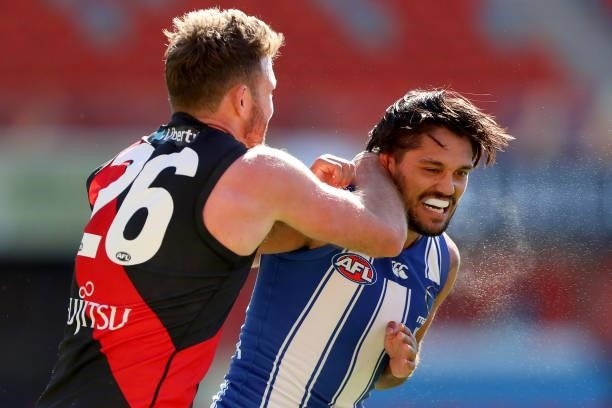 Cale Hooker of Essendon scuffles and collides with Aaron Hall of North Melbourne during the round 18 AFL match between North Melbourne Kangaroos and...