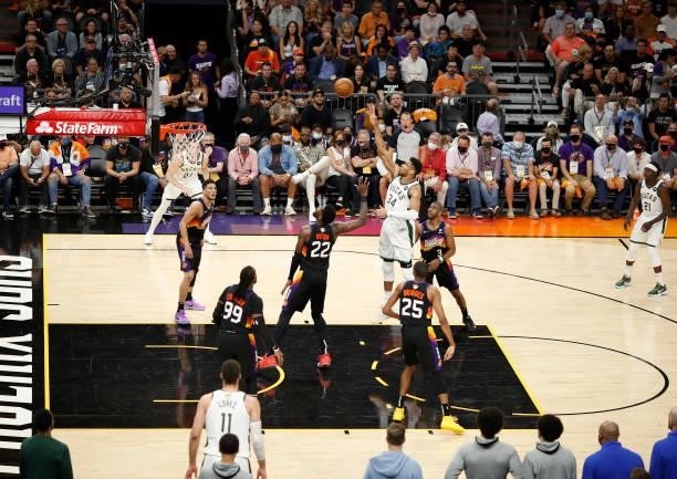 Giannis Antetokounmpo of the Milwaukee Bucks shoots against Deandre Ayton of the Phoenix Suns during the second half in Game Five of the NBA Finals...