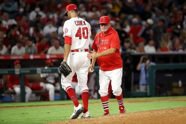 Joe Maddon of the Los Angeles Angels takes the ball from Steve Cishek during the eighth inning against the Seattle Mariners at Angel Stadium of...