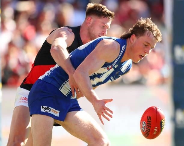 Jayden Laverde of Essendon and Nick Larkey of North Melbourne compete for the ball during the round 18 AFL match between North Melbourne Kangaroos...
