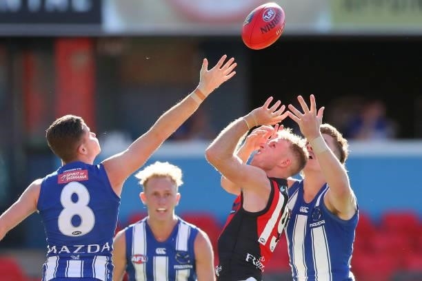 Nick Hind of Essendon and Cameron Zurhaar of North Melbourne competes for the ball during the round 18 AFL match between North Melbourne Kangaroos...