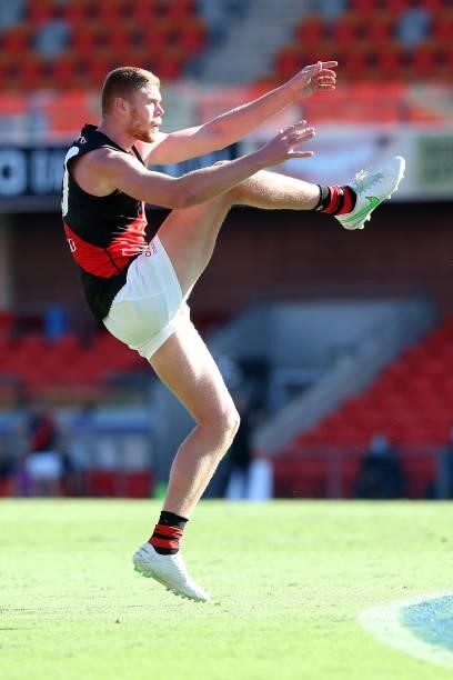 Peter Wright of the Bombers kicks a goal during the round 18 AFL match between North Melbourne Kangaroos and Essendon Bombers at Metricon Stadium on...
