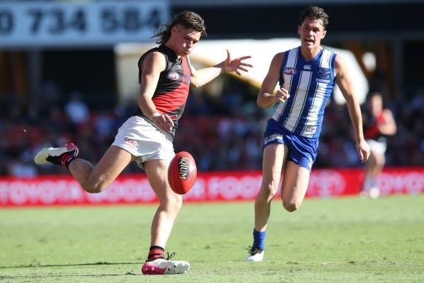 Sam Durham of the Bombers kicks the ball during the round 18 AFL match between North Melbourne Kangaroos and Essendon Bombers at Metricon Stadium on...