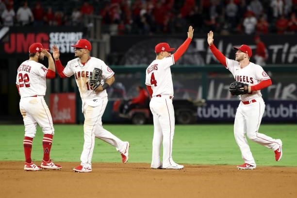 David Fletcher, Juan Lagares, Jose Iglesias and Taylor Ward of the Los Angeles Angels celebrate their 9-3 win against the Seattle Mariners after the...