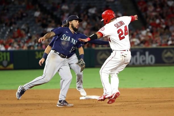 Crawford of the Seattle Mariners tags out Kurt Suzuki of the Los Angeles Angels during the eighth inning at Angel Stadium of Anaheim on July 17, 2021...