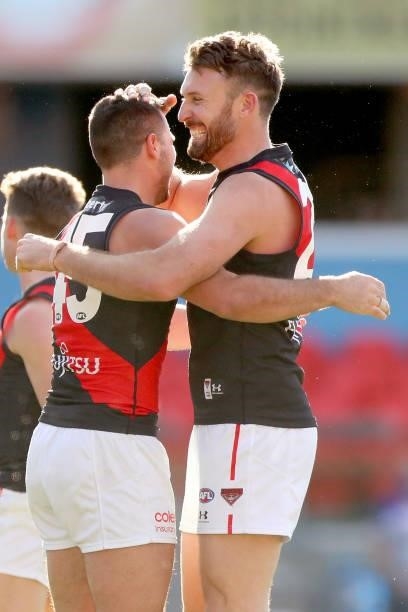 Cale Hooker of Essendon celebrates his goal with team mates during the round 18 AFL match between North Melbourne Kangaroos and Essendon Bombers at...