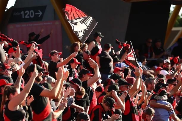 Bombers fans show support during the round 18 AFL match between North Melbourne Kangaroos and Essendon Bombers at Metricon Stadium on July 18, 2021...